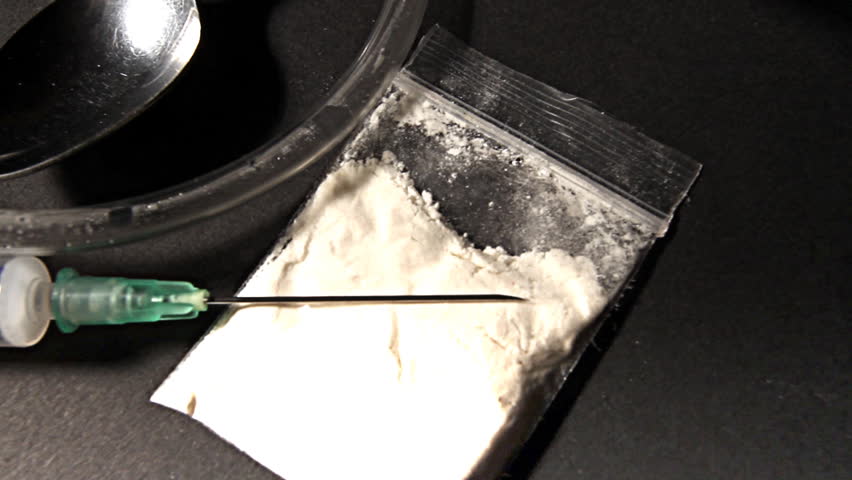 Hard drug - addiction concept. ILLUSTRATION! The white powder is flour before anyone think something else :-)  Studio setup with professional lighting and dolly motion.