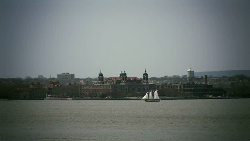 Ellis Island from across river & old sailboat in mid-ground