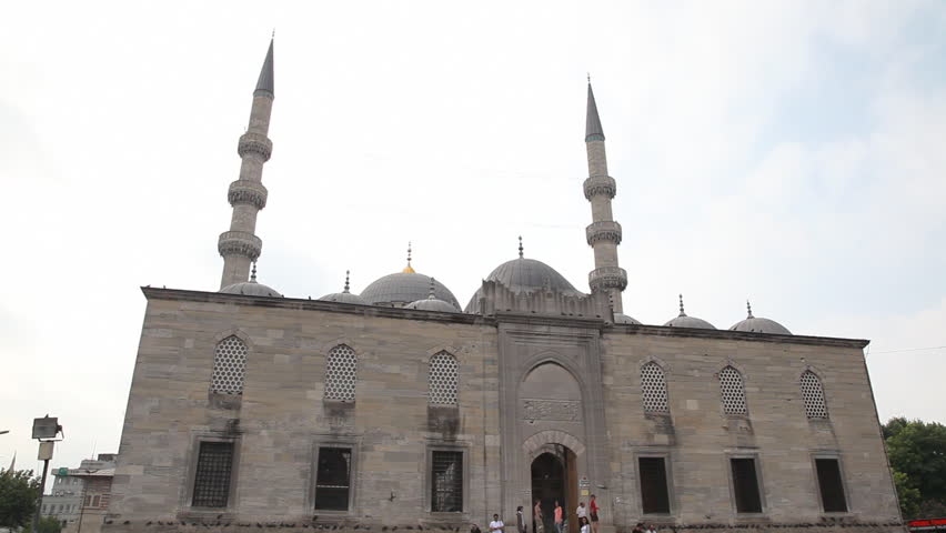 ISTANBUL TURKEY - JULY 30: Visitors outside the Yeni Cami Mosque in Istanbul July 30 2011. The Yeni Camii Mosque  is an Ottoman imperial mosque located in the Eminu district of Istanbul, Turkey. 
