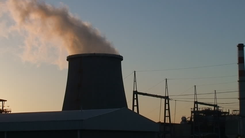 Chimneys of nuclear power plant, cooling towers emitting steam 