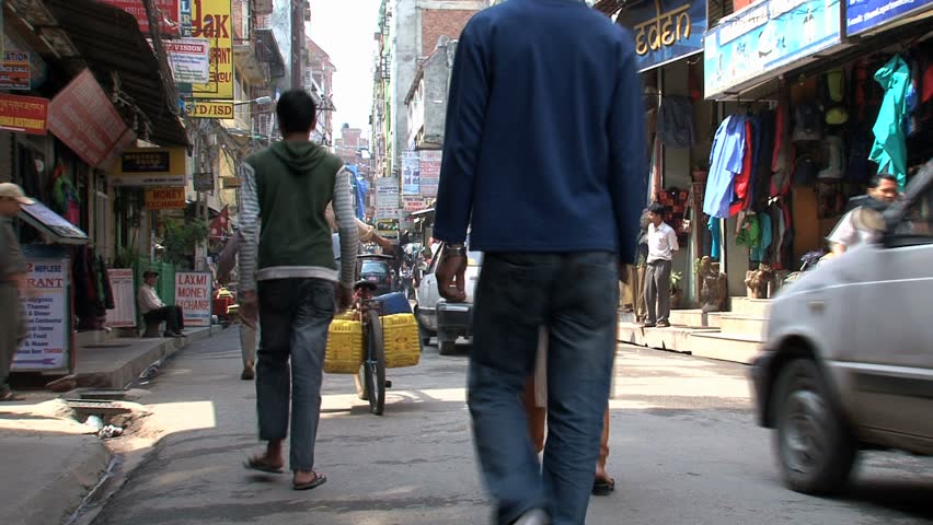 KATHMANDU - CIRCA 2010: People, cars and bikes circulate through the city circa 2010 in Kathmandu.