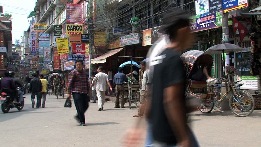 KATHMANDU - CIRCA 2010: People, cars and bikes circulate through the city circa 2010 in Kathmandu.