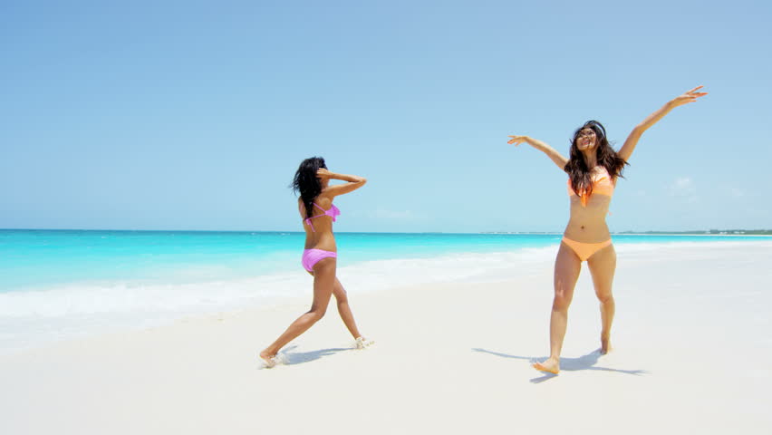 Happy Bikini Woman Jumping Of Joy And Success On Perfect White Sand