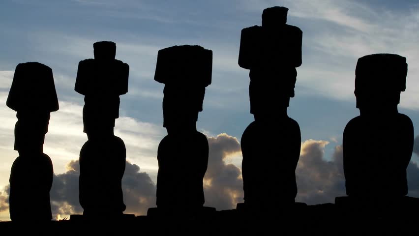 Clouds move behind Easter Island statues.