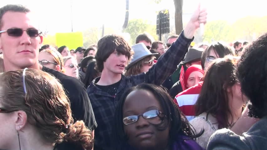 WASHINGTON, DC - CIRCA 2010: A man holds up an American flag with a peace sign on it at a political rally circa 2010 in Washington DC.
