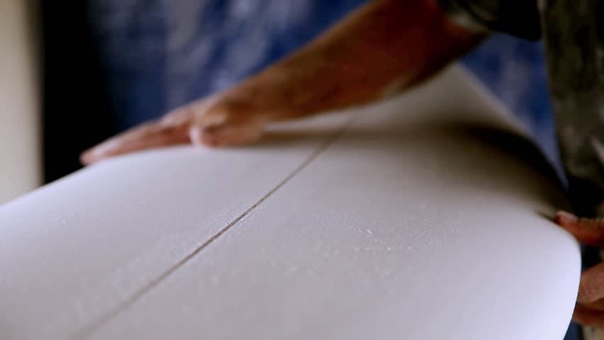 A man making a surfboard
