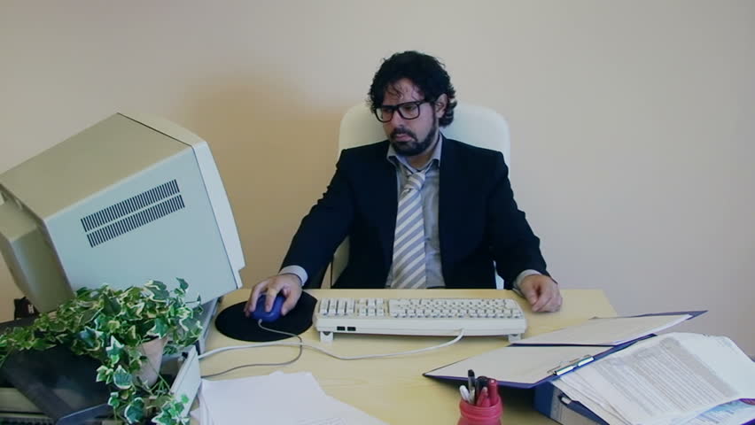 A male employee at work in the office is annoyed and depressed. The boss scolds him, he gets back to work.