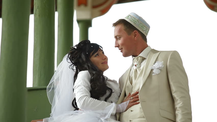 Young Crimean Tatar couple on the steps of the Big Khan Mosque in Bakhchisaray Palace. Bakhchisaray, Crimea, Ukraine