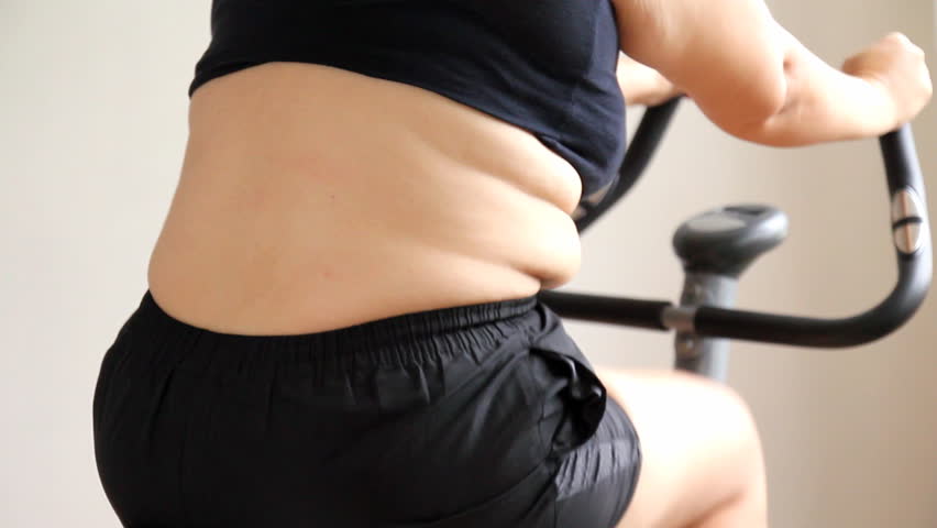 Obese woman exercising on a stationary bike