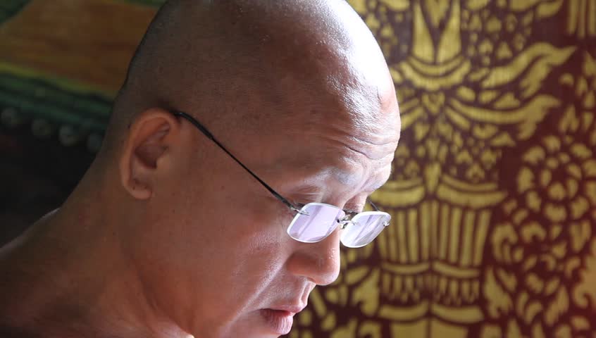CHIANG MAI, THAILAND - CIRCA AUGUST 2011 - Buddhist monk in Wat Chiang Mun reads buddhist text, circa August 2011, Chiang Mai, Thailand. Buddhism in Thailand is represented by the presence of Buddhist monks who are responsible for preserving Buddha's teac
