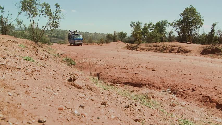 KENYA, AFRICA - CIRCA 2009: A van crowded with travelers makes its way along a dirt road circa 2009 in Kenya.