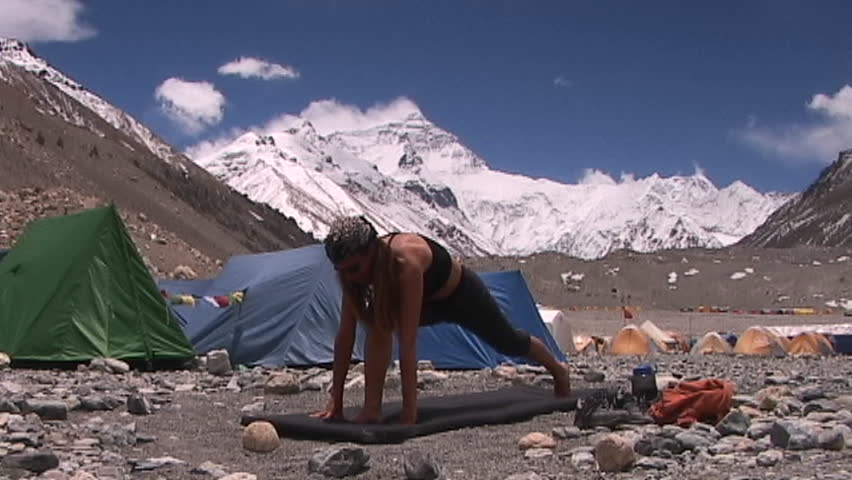 MOUNT EVEREST, TIBET - CIRCA 2005: Attractive woman does yoga at Mt. Everest base camp circa 2005 in Tibet.