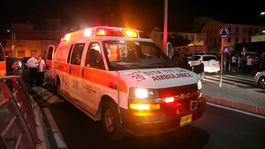 HAIFA, ISRAEL - SEPTEMBER 03: Ambulance evacuates a wounded person after a demonstration for social justice, September 03 2011 Haifa, Israel.