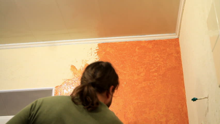 Master applies colored wax on ornamental plaster. 