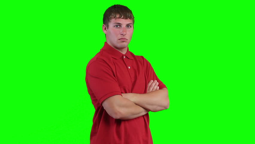 Young man looks at camera with an attitude, then shifts and smiles.