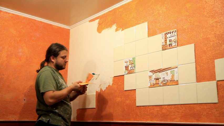 Master applies colored wax on ornamental plaster. 