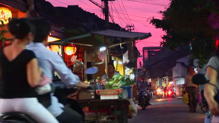VIETNAM - CIRCA 2009: Vendors wheel their wares out at dusk on a busy street circa 2009 in Vietnam.
