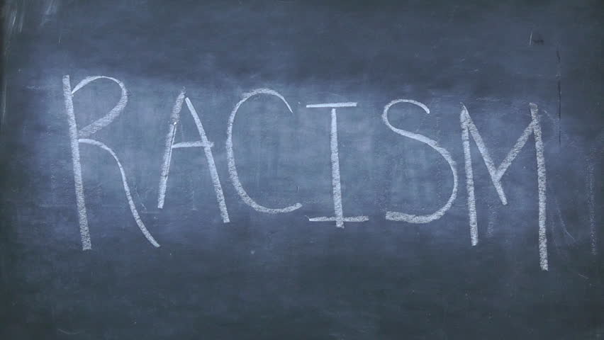 Erase Racism - word is erased from a chalkboard