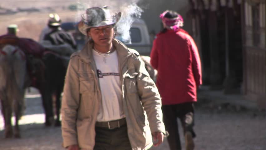 BEIJING, CHINA - CIRCA 2009: A cowboy walks alone through  town circa 2009 in Beijing.