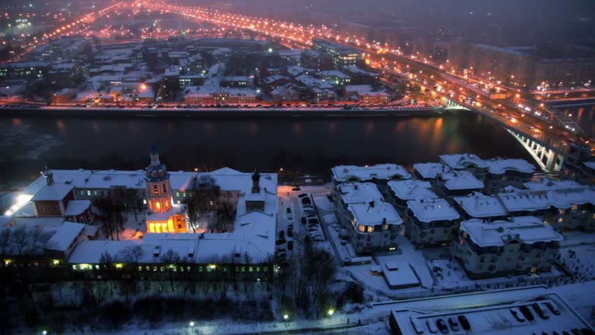 Panorama of night city, church on quay, traffic on third transport ring, bridge over river, at winter in Moscow
