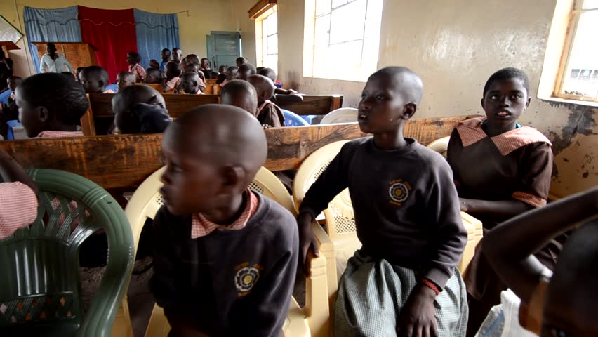MASAI MARA, KENYA - OCTOBER 17: Unidentified schoolboys sit in a  school funded by tourists' donations on October 17, 2011 in Masai Mara, Kenya. 