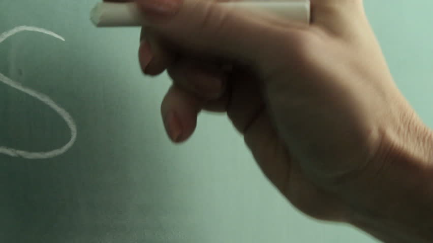 A hand draws dollar signs on a chalkboard