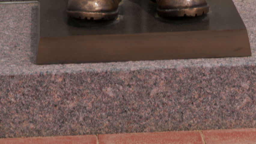 Bronzed memorial to fallen soldiers in battle. Pan up. 