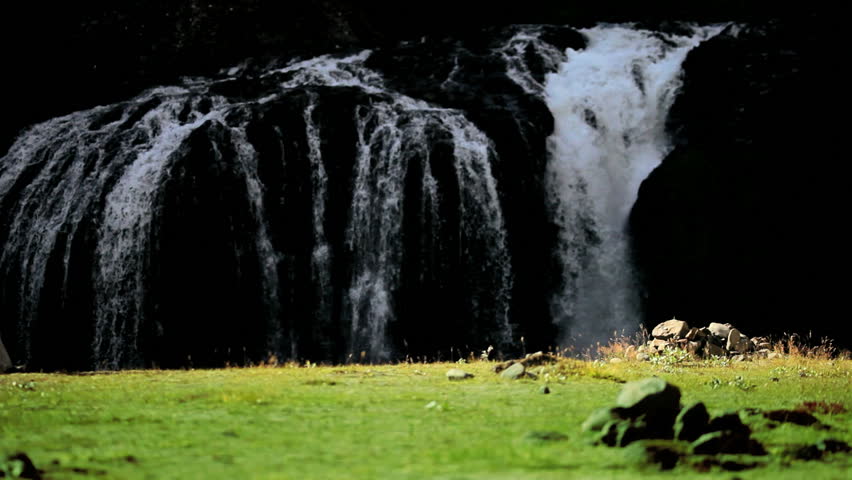 Female by Waterfall on Hiking Expedition