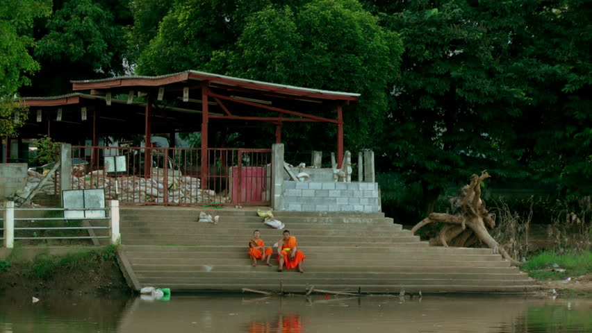 CHIANG MAI, THAILAND - CIRCA OCTOBER 2011 -  Monks survey the damage caused by the 2011 Thailand floods.
