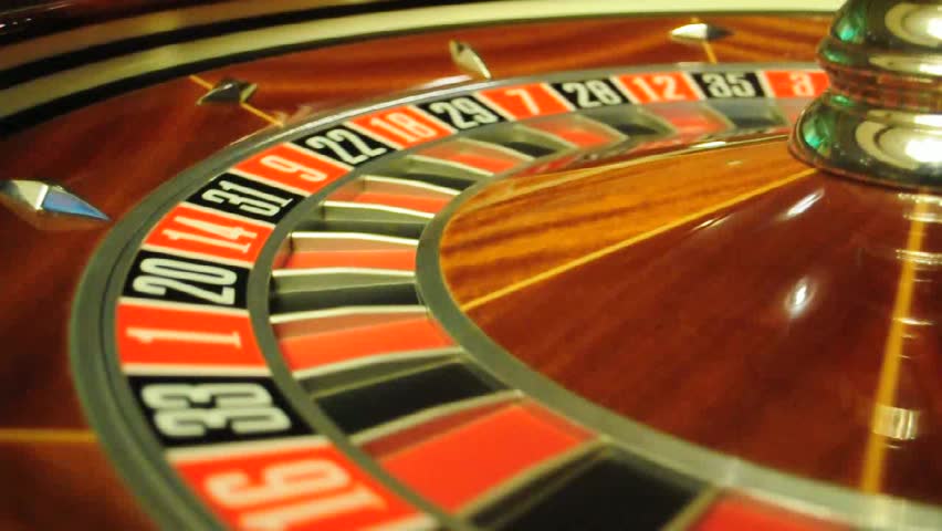 image with a casino roulette wheel with the ball on number 0