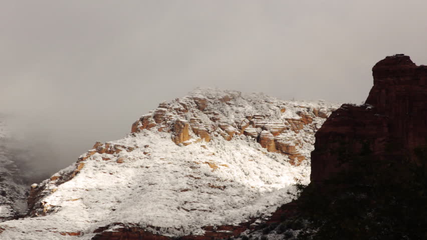 Clouds move over the landscape of rock formations in Sedona, Arizona following the first snow of the season. Shot Nov 5, 2011.
