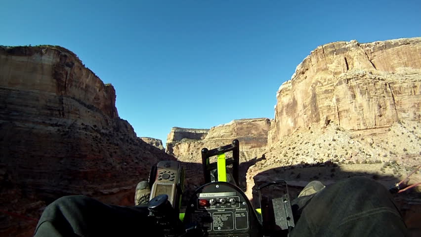 Ultralight Sport aircraft deep in desert canyon with mild turbulence in remote San Rafael Swell area of south east Utah. Sheer cliffs and river carving beautiful canyon. View point of the pilot.