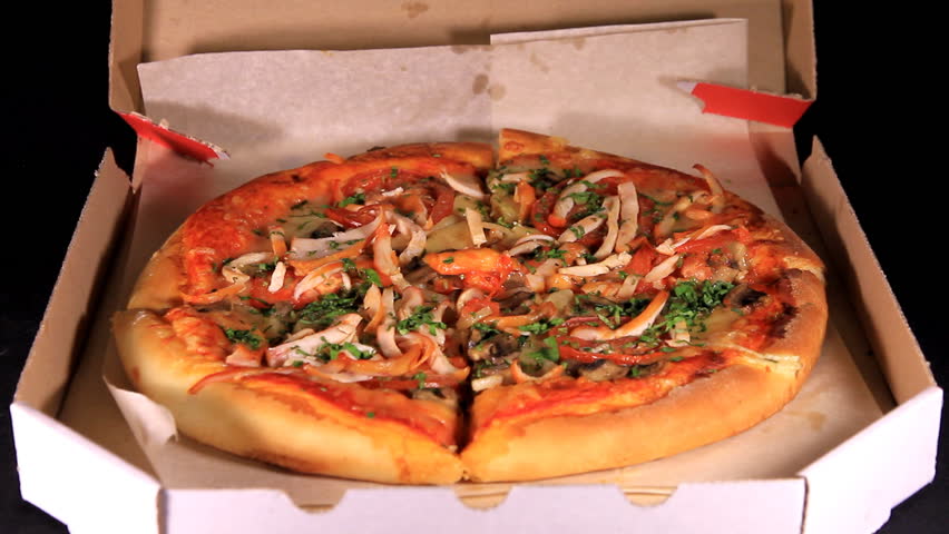 Hands of the people take to pizza, which have right before delivered
