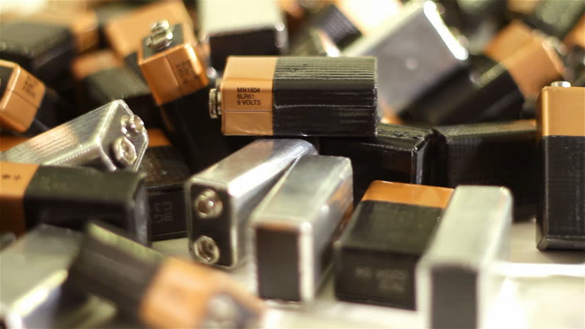 A pile 9-volt batteries spinning on a turntable with shallow depth of field.
