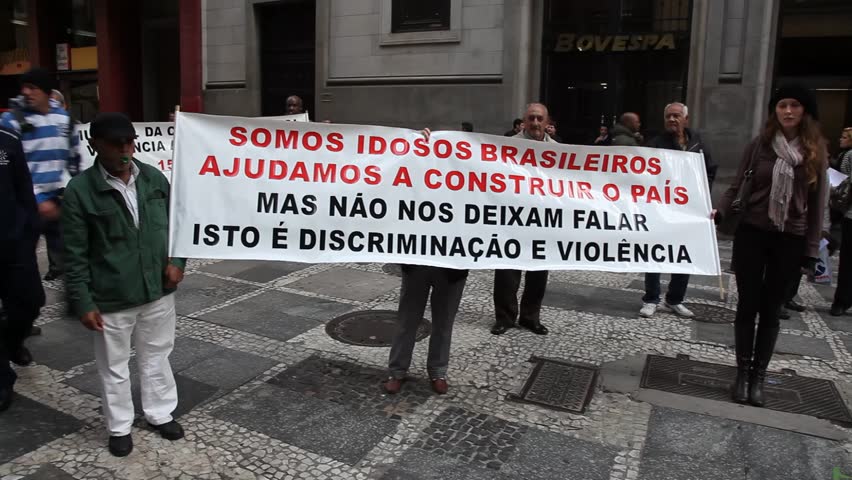 SAN PAULO, BRAZIL - CIRCA JUNE 2011: Demonstrators hold up banners protesting discrimination and violence against females and elderly circa June 2011 in San Paulo.