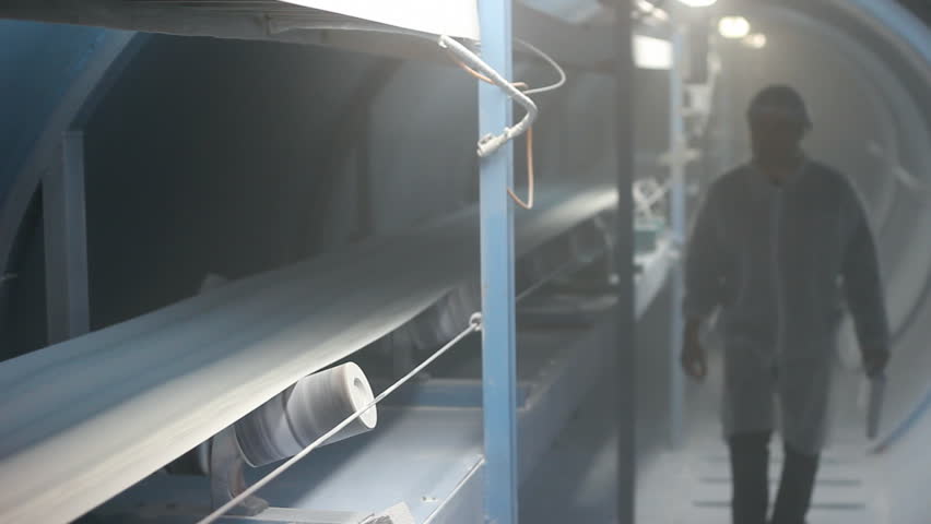Worker controls the quality of sugar on the production line