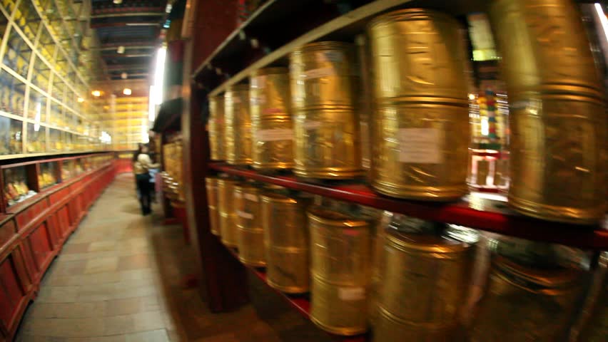 MONGOLIA - JULY 10, 2009: Woman spins prayer wheels in Gandan Monastery on July 10, 2009 in Mongolia.