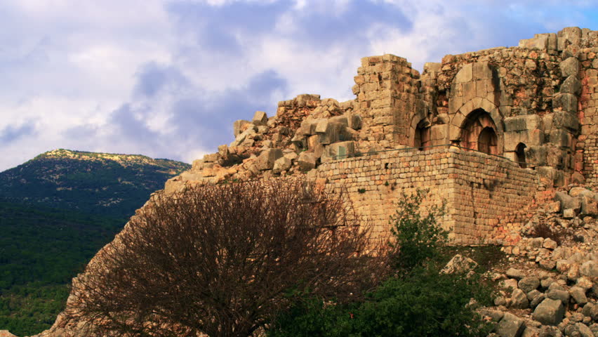 Nice wide shot of the ruined entry into the Nimrod Fortress in the Golan Heights, Israel, with rolling clouds, wind, and mountains in the background.  02/21/2011
