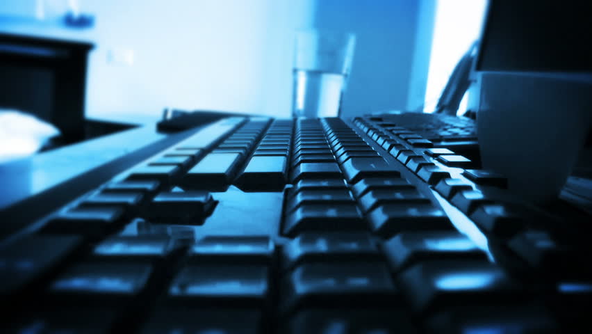 Typing on Computer Keyboard, time lapse, blue tint