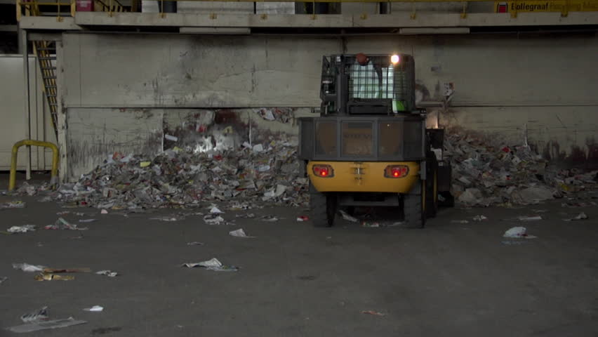ORLANDO, FL - CIRCA 2009: Bulldozer relocates large mounds of paper circa 2009 in Orlando.