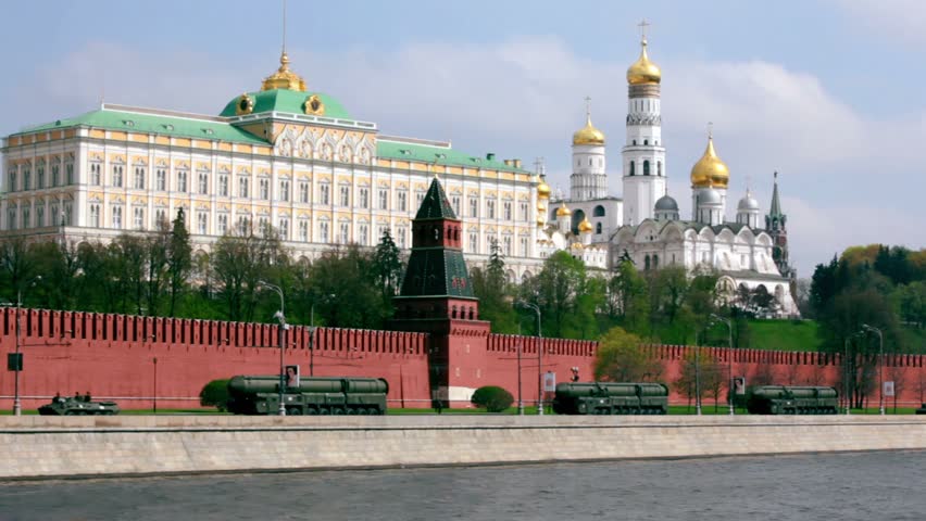 Rockets motorcade ride by quay of Moscow Kremlin, red brick walls and Ivan Great Bell Tower. Victory Day 1945 year. Russia.