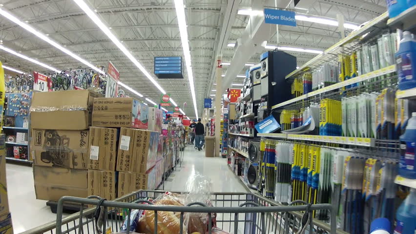 Grocery shopping from view of a shopping cart. Walking through the automotive, car and truck auto department.