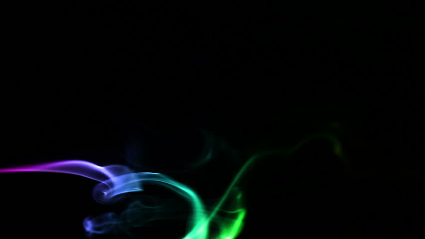 Multicolored smoke forming waves on Black background