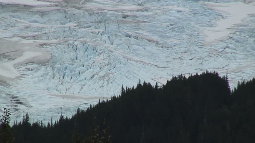 Amazing "static shot", stationary Of Glacier Behind Silhouette Of Forest