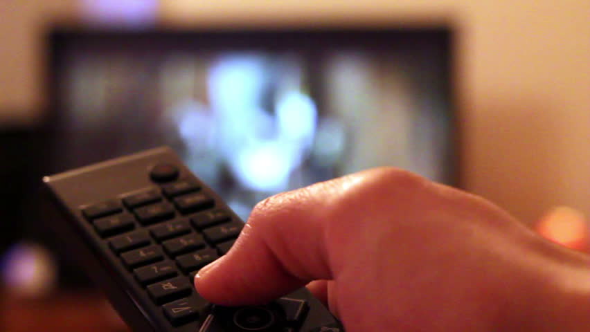 Watching TV-changing channels, blurred TV 
