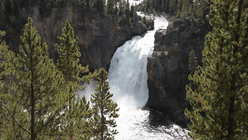 Famous and beautiful Upper Yellowstone Falls. Several hundred feet tall falling from the river into the Grand Canyon of the Yellowstone. Wyoming. National Park nature and wilderness area. 