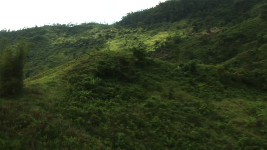 HD: Helicopter circles natives hiking over mountain #1