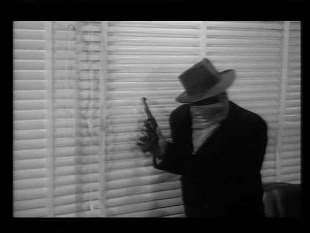 Gangsters looking through venetian blinds during robbery