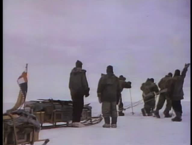 Rear view of men setting off on an arctic expedition