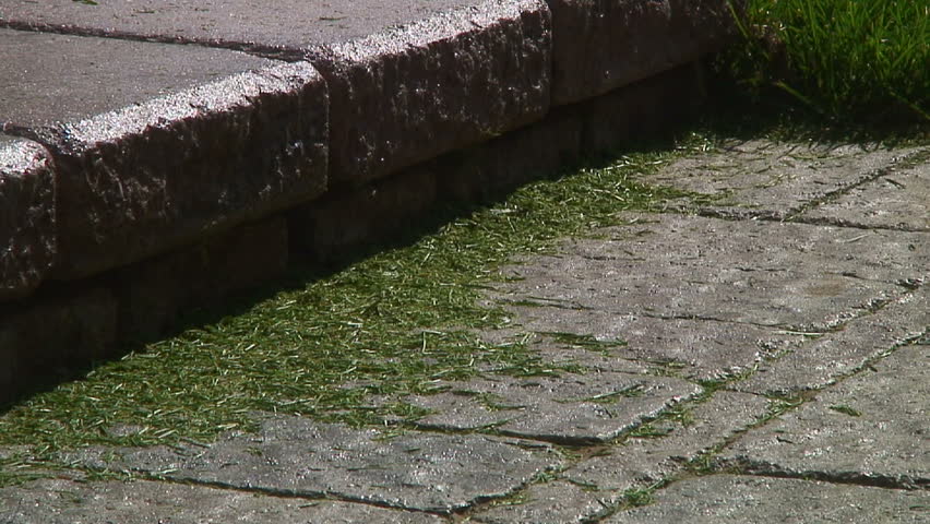 Sweeping up the grass clippings.